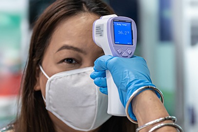 Dental team member taking patient's temperature