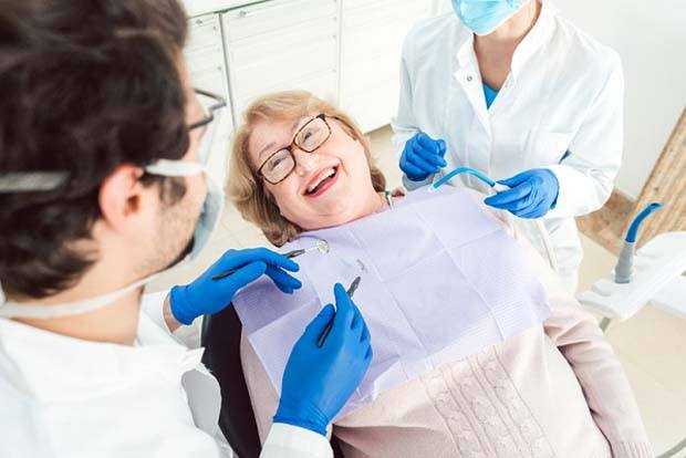 Closeup of senior woman smiling at dentist in Bedford