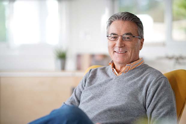 Closeup of mature man smiling with dentures in Bedford