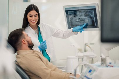 Dentist and patient looking at X-ray together