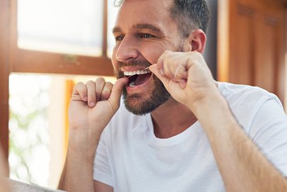 Man flossing his teeth