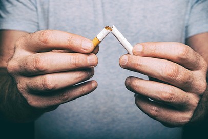 Man breaking a cigarette