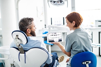 dentist explaining X-rays to patient