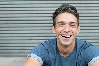 man smiling after getting dental implants 