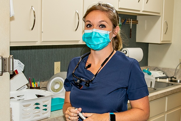 Dental team member in lab and sterilization area