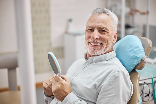 man smiling in treatment chair 