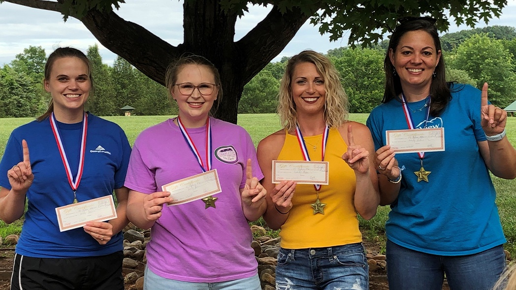 Dental patients holding awards and wearing medals