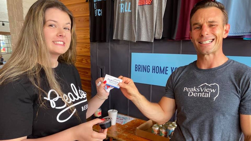 Dentist giving dental patient a business card