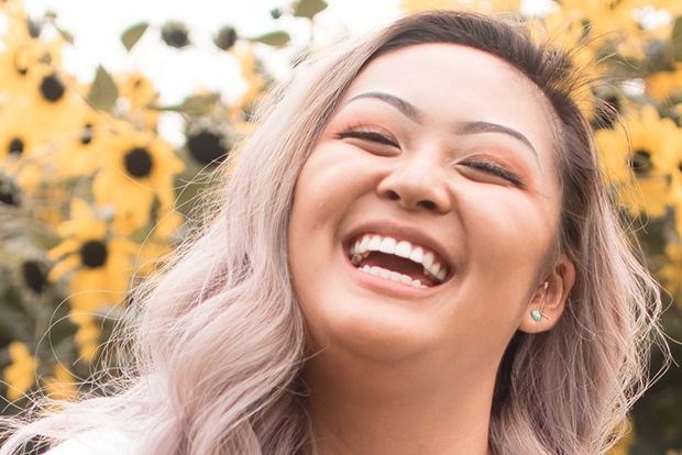 Woman sharing bright smile after teeth whitening