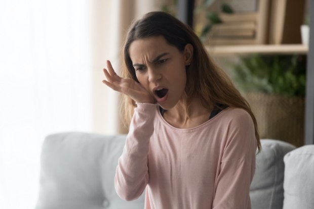 Woman with jaw pain holding cheek