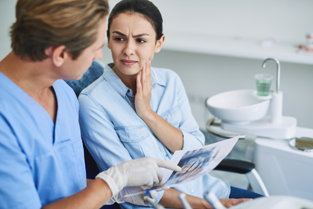 Patient in Bedford talking to dentist about tooth extraction