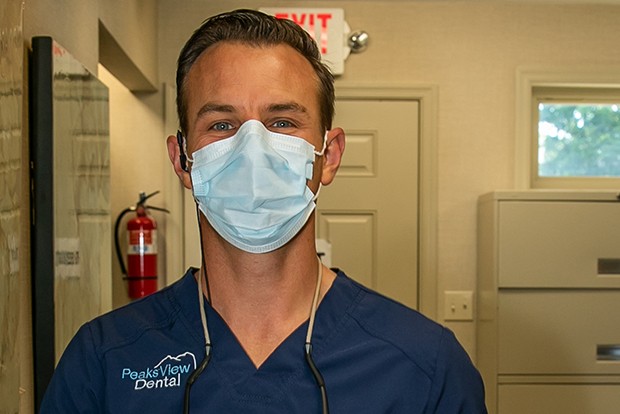 Dentist wearing face mask in state of the art dental office
