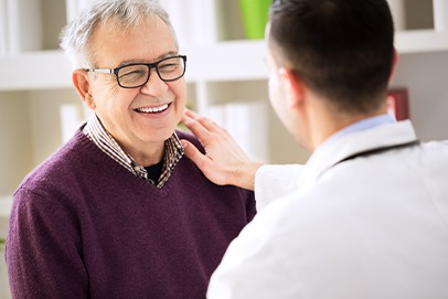 Dentist talking to patient about dental implant tooth replacement