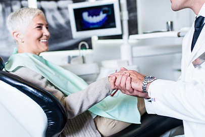 Dentist and dental patient shaking hands