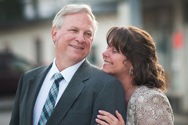 Man and woman smiling after dental implant tooth replacement