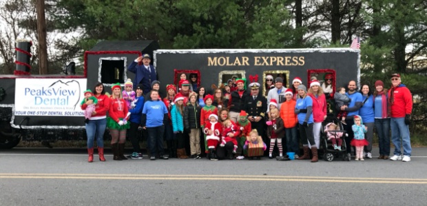 Dental team members volunteering at a community event with the Molar Express