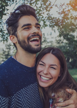 Man and woman smiling after preventive dentistry visit