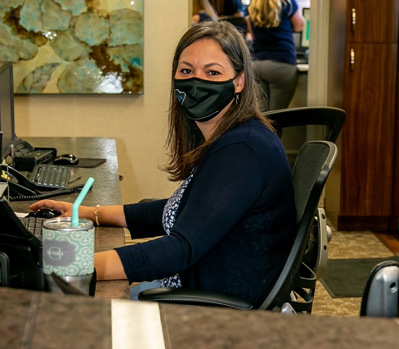 Dental team member updating dental patient's electronic chart