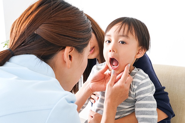 Child receiving an exam after pulp therapy