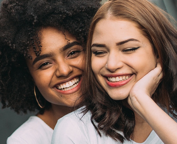 Two women with healthy smiles after preventive dentistry