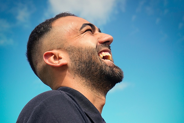 Man with healthy smile after oral surgery