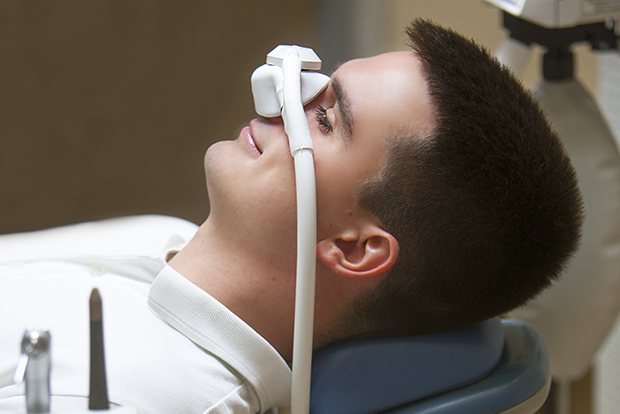 Relaxed patient with nitrous oxide dental sedation mask in place
