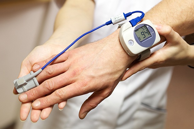 Patient with at home sleep apnea testing device on their wrist