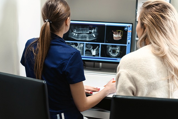 Dental team members looking at all digital x-rays
