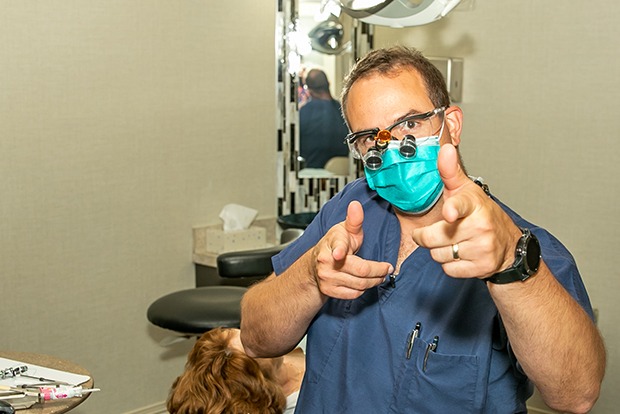 Dentist smiling in dental treatment room