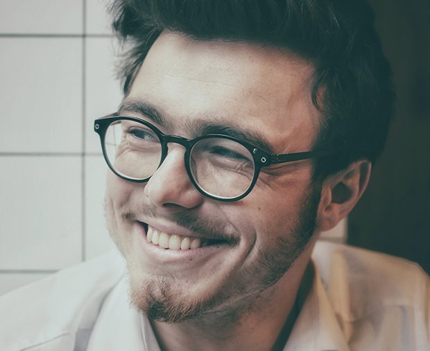 Man with attractive smile after porcelain veneers