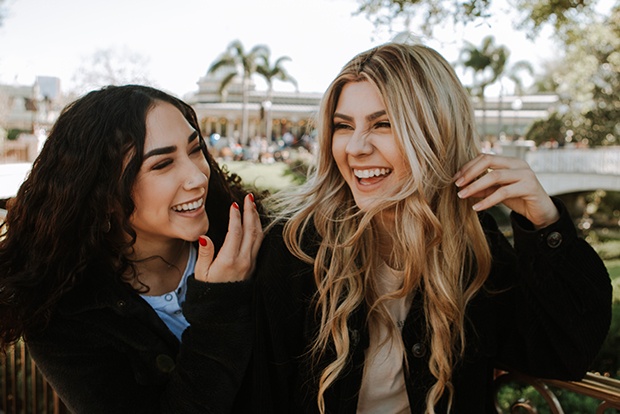 Two women with beautiful smiles after porcelain veneers