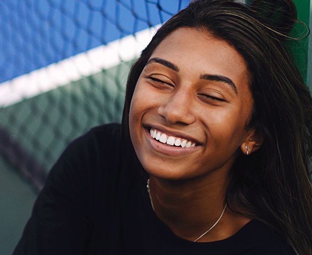 Woman with flawless smile after teeth whitening