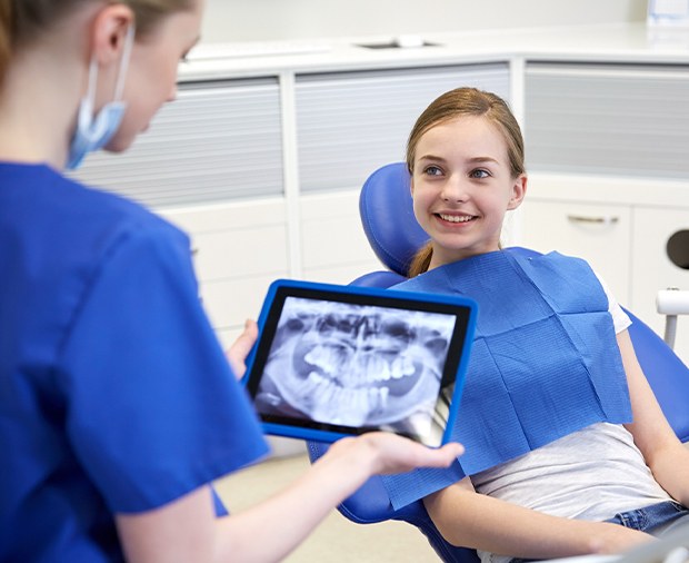 Dentist examining child's digital x-rays