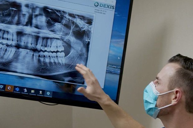 Dentist examining digital x-rays