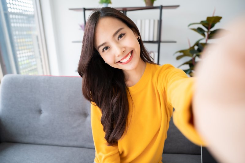 a woman enjoying the benefits of porcelain veneers in Bedford